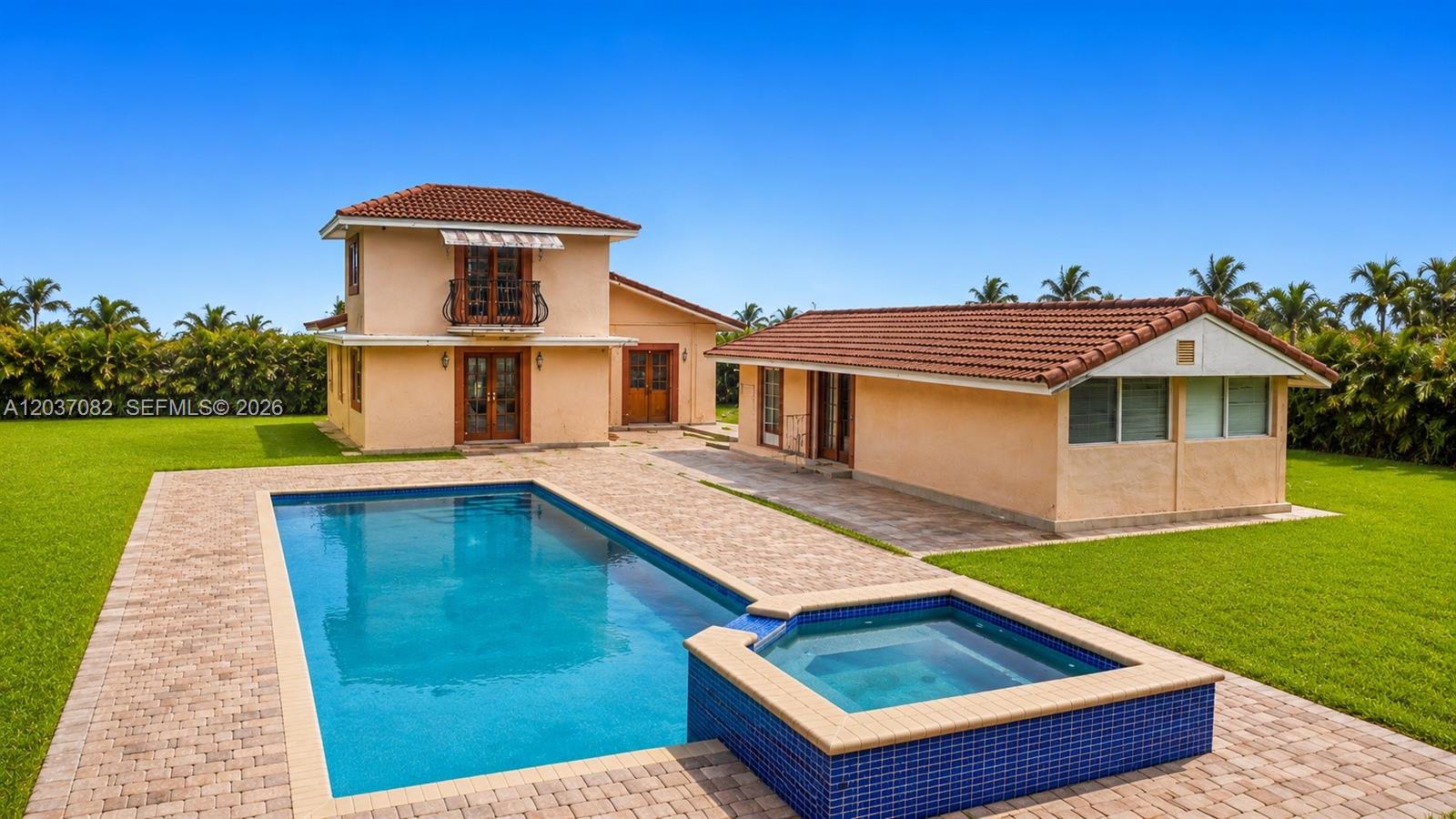 A two-story house and a detached structure sit beside a pool and hot tub — 300 SW 123rd Ave, Miami FL 33184, MIAMI, FL