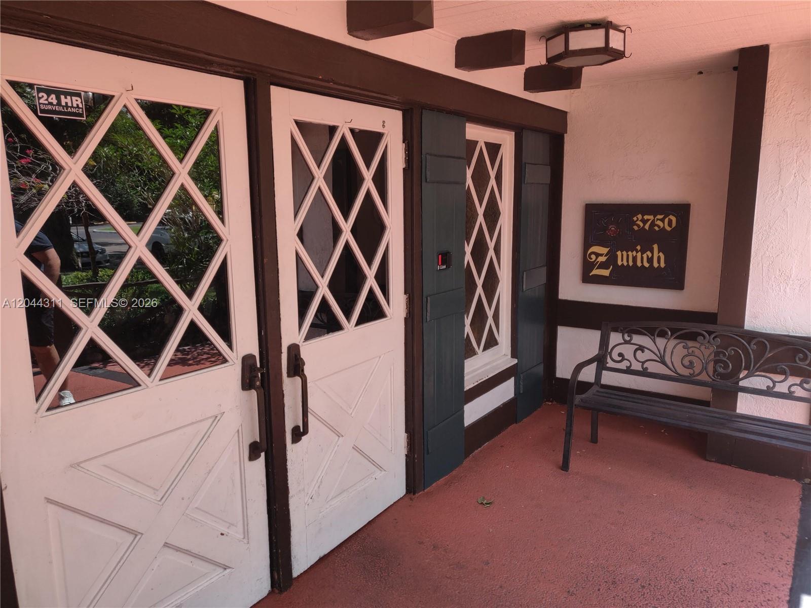 A covered entryway features two white diamond-paned doors, a bench, and a sign — 3750 Inverrary Dr # 2Q, Lauderhill FL 33319, LAUDERHILL, FL