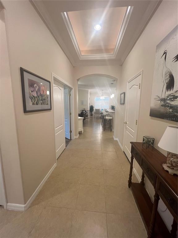 A tiled hallway with a tray ceiling leads toward an open kitchen and dining area — 1829 KNIGHTS BRIDGE TRAIL, PORT CHARLOTTE, FL