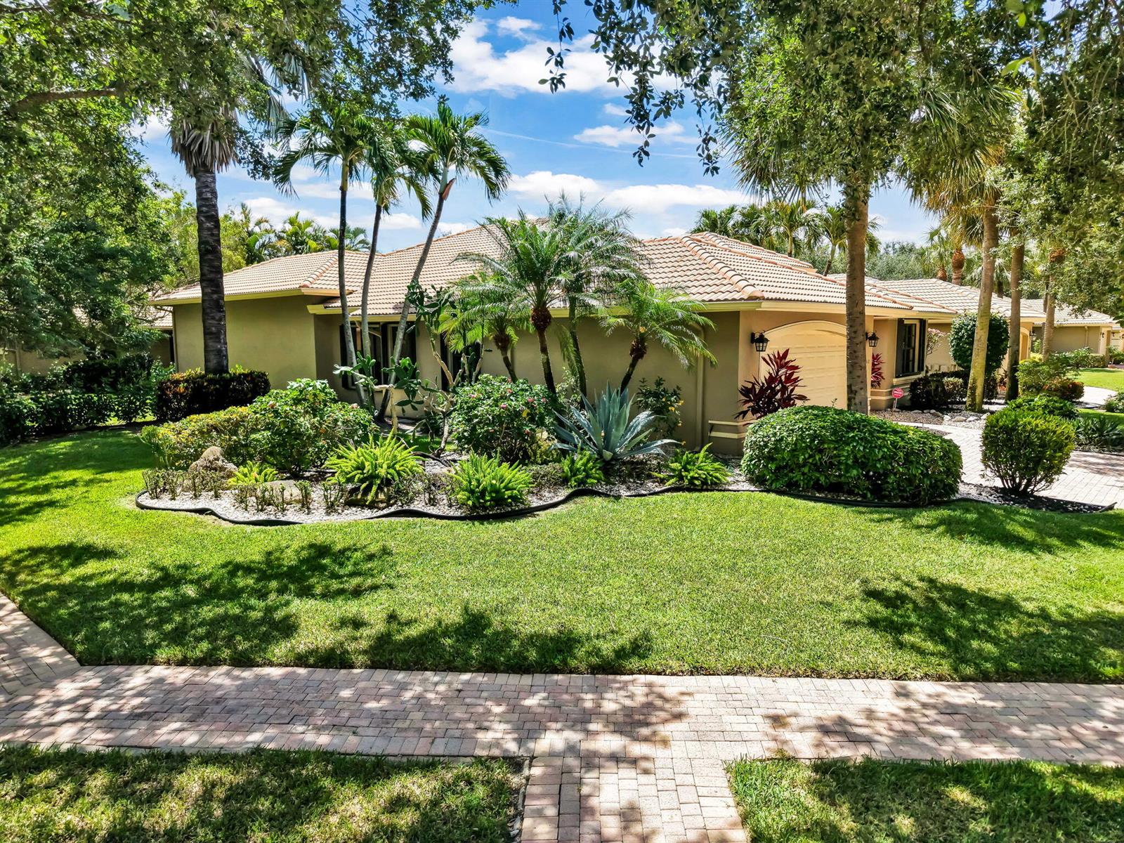 A single-story house with a tiled roof, palm trees, and a landscaped front yard — 11012 Vía Sorrento, Boynton Beach FL 33437, BOYNTON BEACH, FL