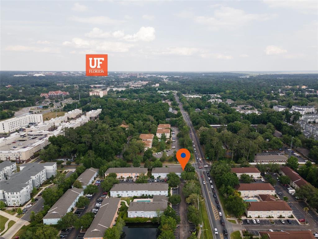 An aerial view shows apartment complexes and a road near the University of Florida campus — 3860 SW 20TH AVENUE UNIT 1808, GAINESVILLE, FL