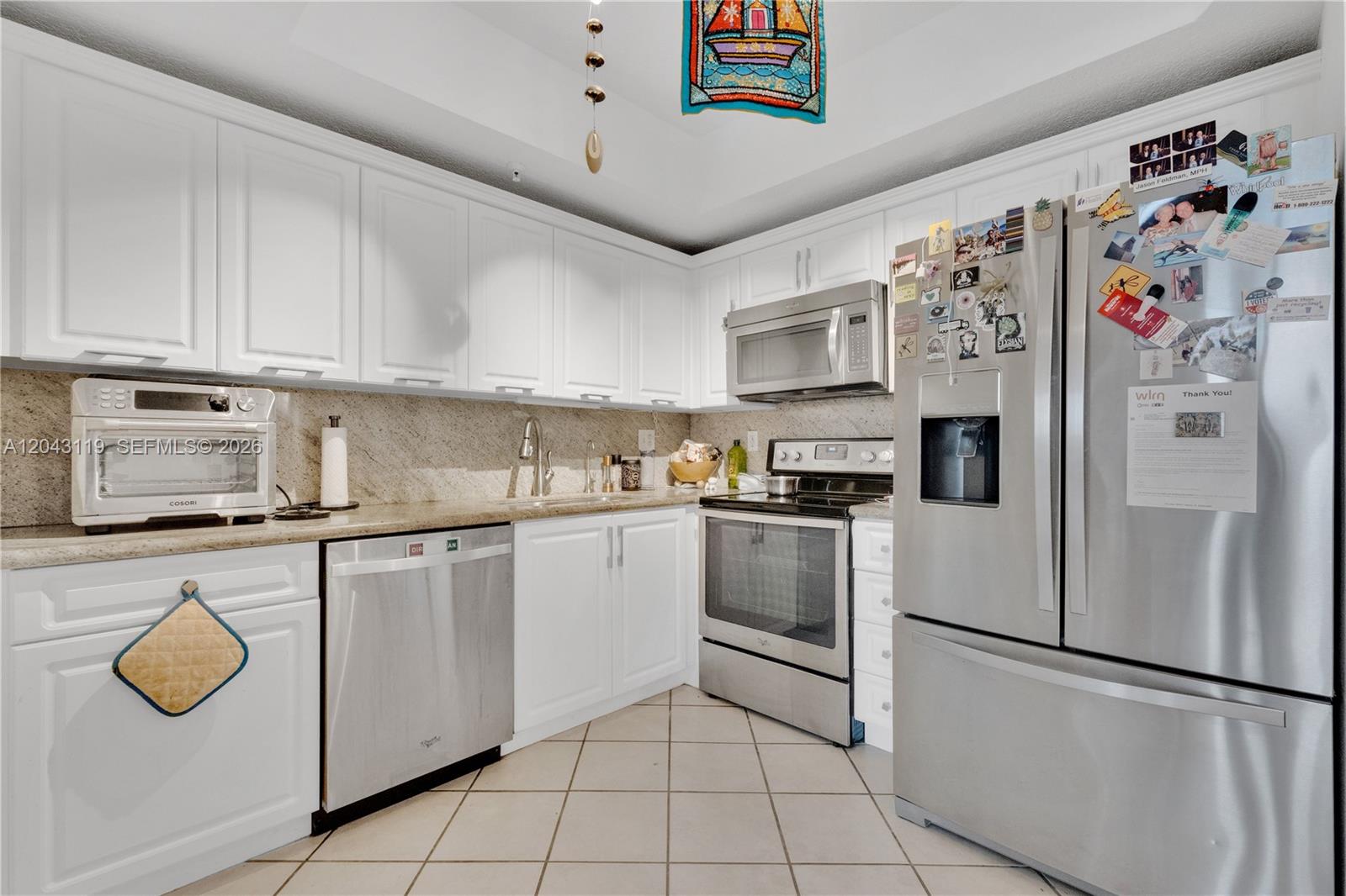 A kitchen with white cabinets, stainless steel appliances, and beige granite countertops — 3500 Coral Way # 10, Miami FL 33145, MIAMI, FL