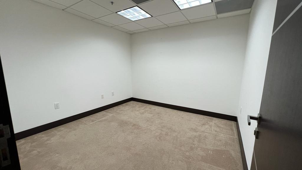 An empty office space features white walls, tan carpeting, and a drop ceiling — 2730 SW 3rd Avenue # 202N, Miami FL 33129, MIAMI, FL