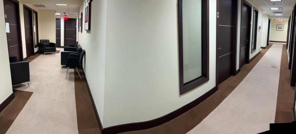 A wide-angle view of an office hallway with beige carpeting, dark doors, and waiting chairs — 2730 SW 3rd Avenue # 202N, Miami FL 33129, MIAMI, FL