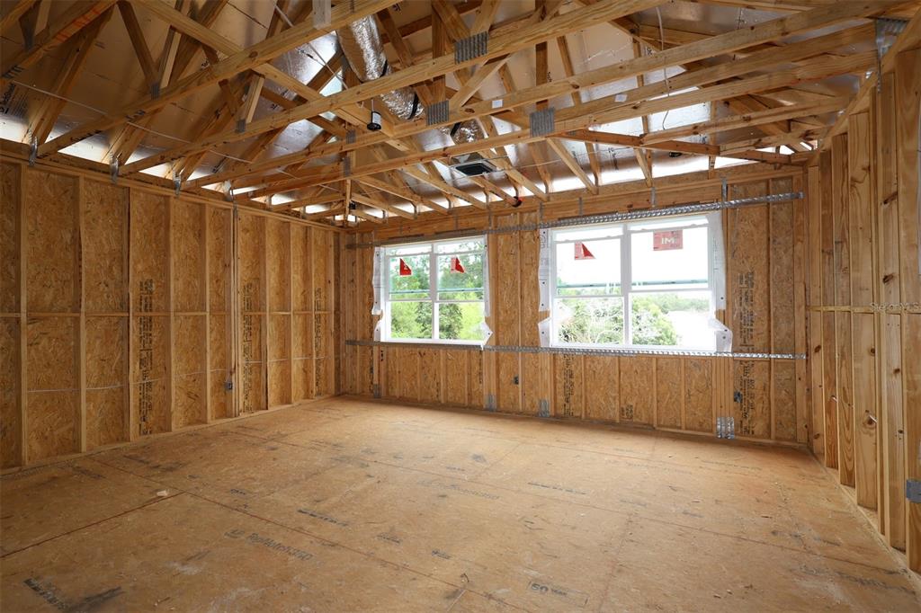 An interior view of a house under construction featuring exposed wood framing and concrete block walls — 2670 RAVENCLIFFE TERRACE, OVIEDO, FL