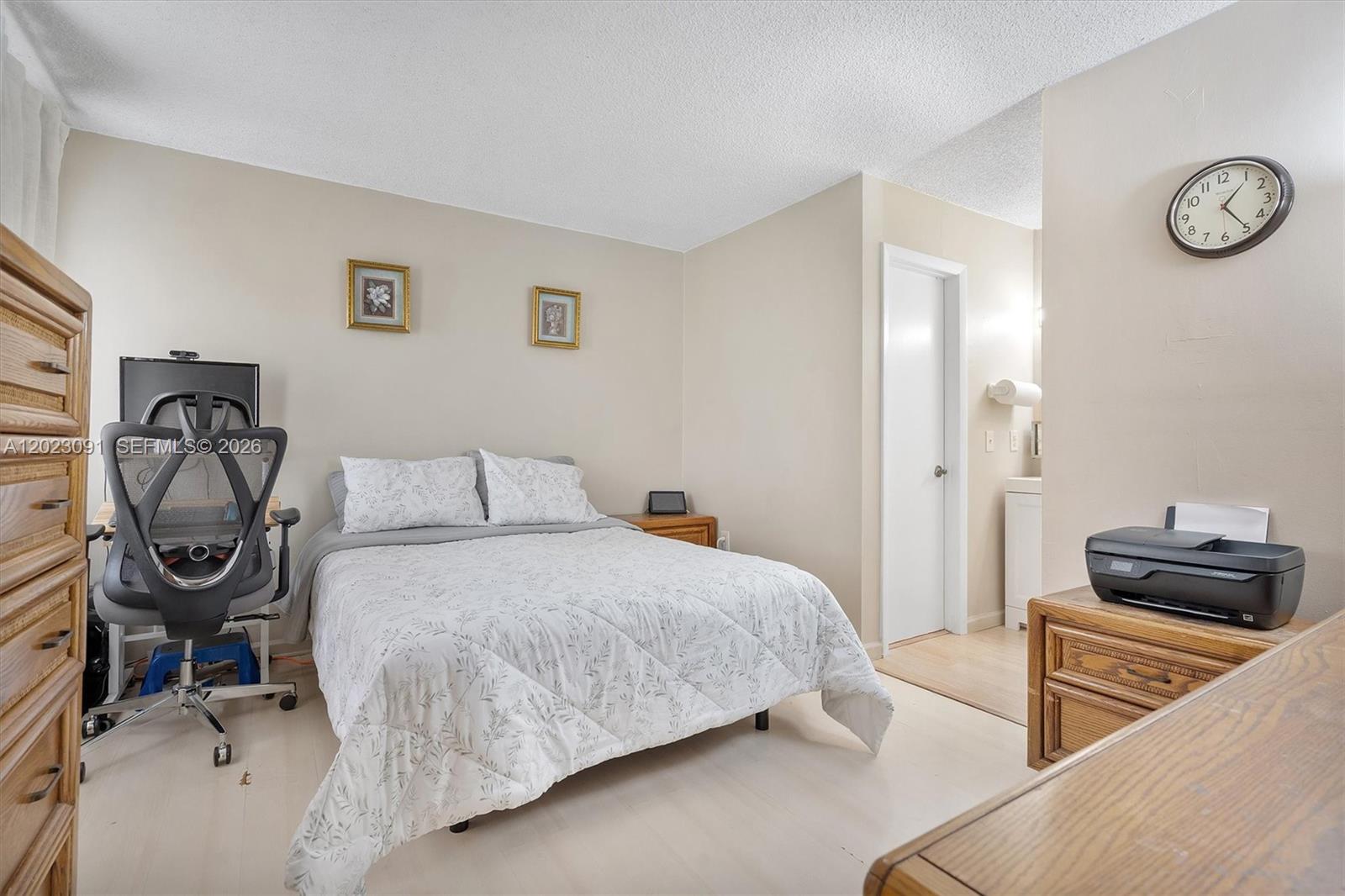 A bedroom features a bed, a desk with an office chair, and an attached bathroom — 15635 SW 74th Cir Dr # 11, Miami FL 33193, MIAMI, FL