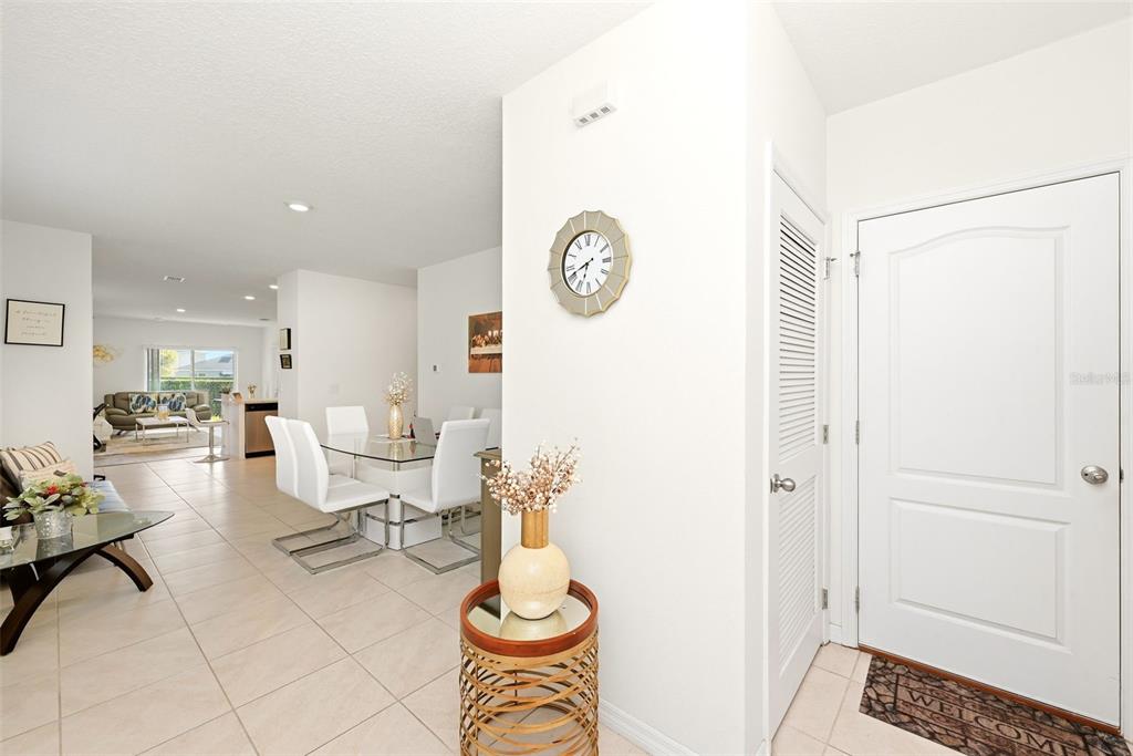 An entryway leads into a dining area and living room with tile flooring throughout — 1791 POST OAK DRIVE, DAVENPORT, FL
