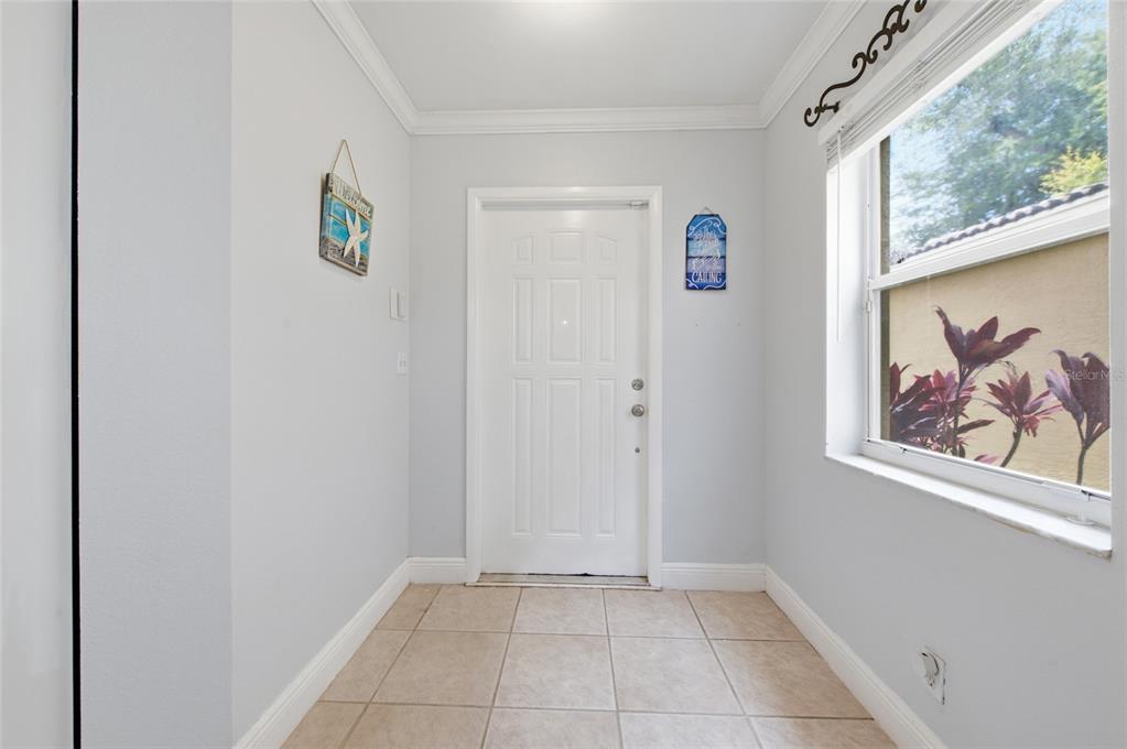 A two-story house with a beige stucco exterior, a two-car garage, and a tiled roof — 4258 NW 1ST DR, DEERFIELD BEACH, FL