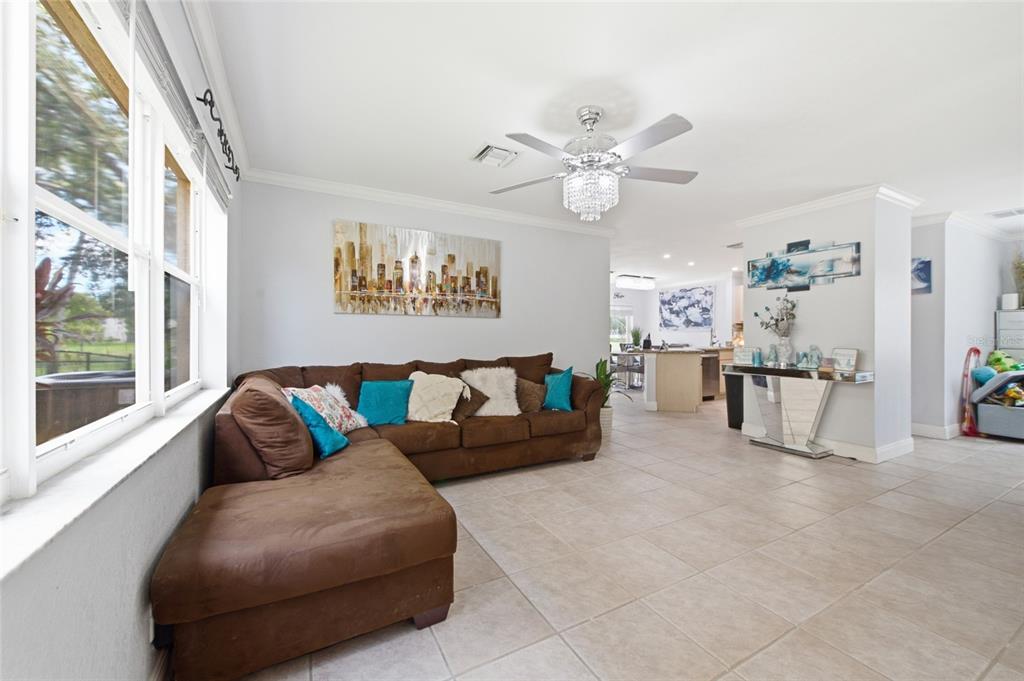 A two-story house with a white garage door, tan stucco walls, and a tiled roof — 4258 NW 1ST DR, DEERFIELD BEACH, FL