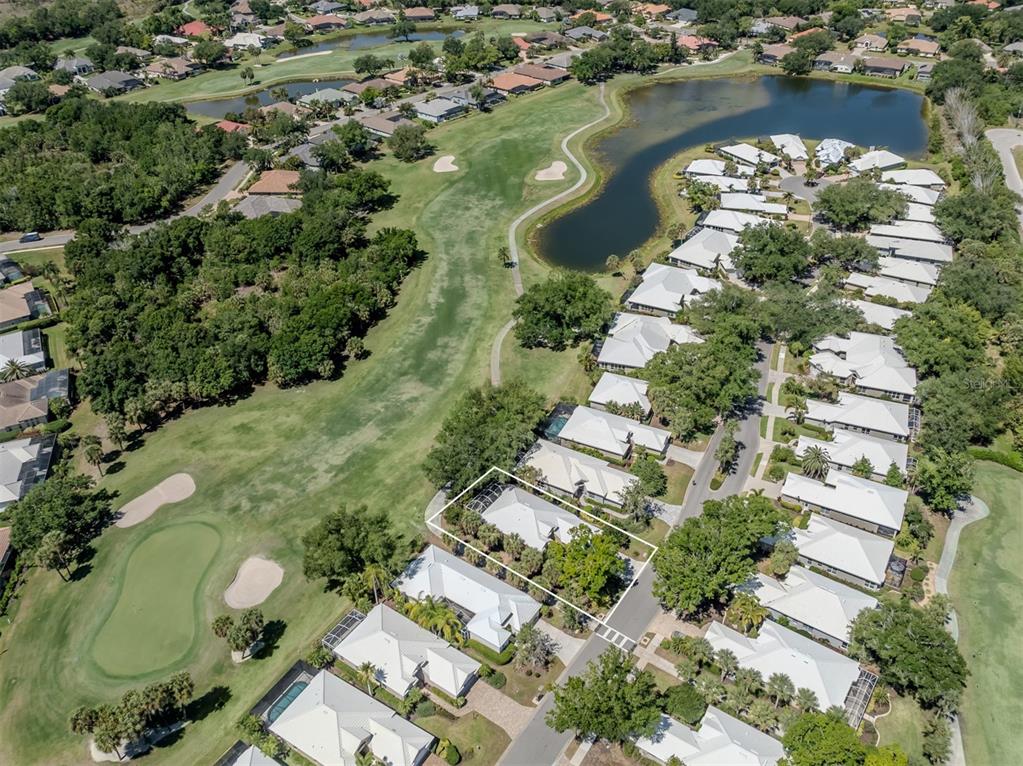 An aerial view shows a residential neighborhood with a highlighted house bordering a golf course — 535 FALLBROOK DRIVE, VENICE, FL