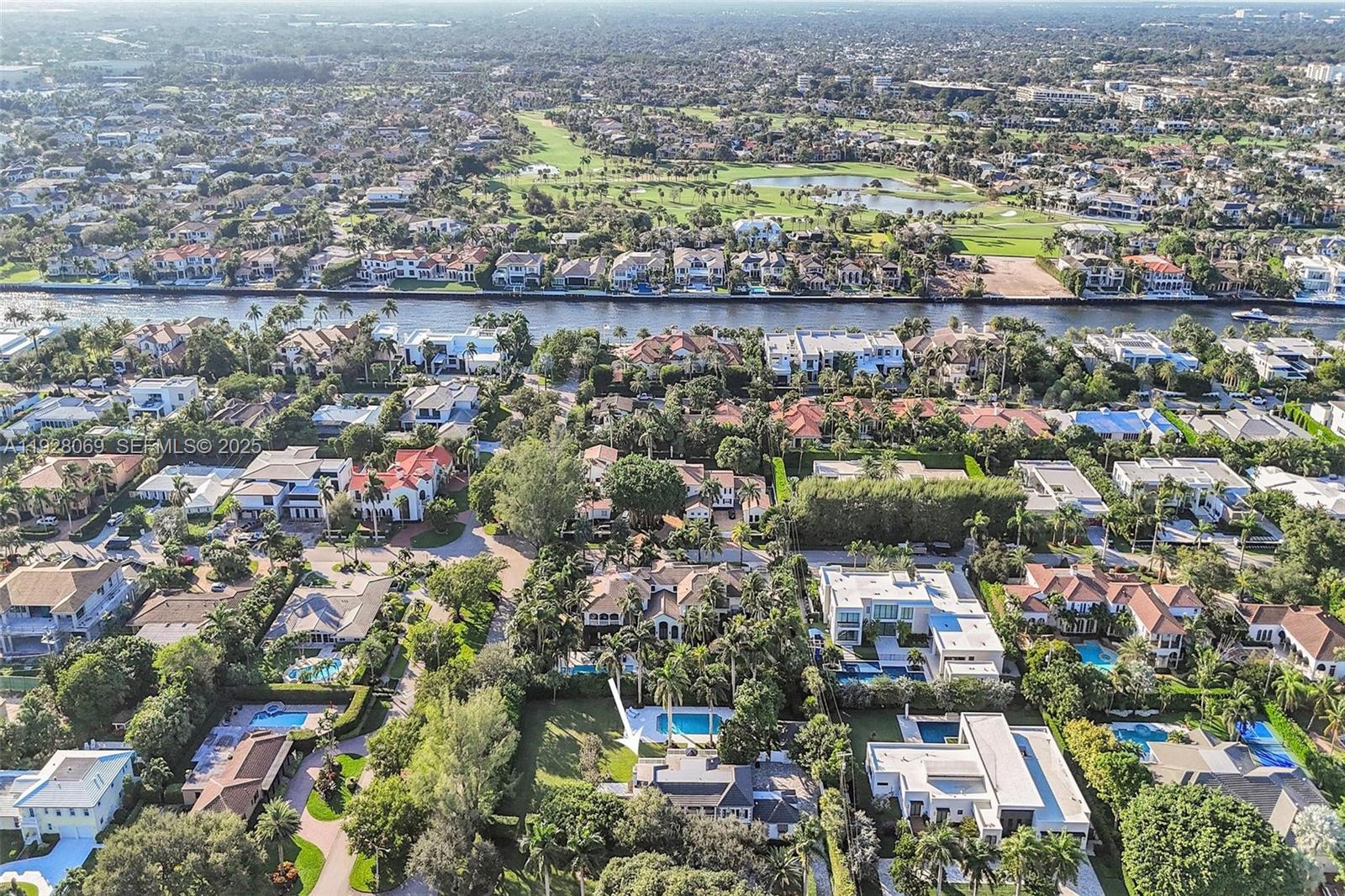 An aerial view shows a residential neighborhood with houses, swimming pools, and a waterway — 1281 Banyan Rd, Boca Raton FL 33432, BOCA RATON, FL