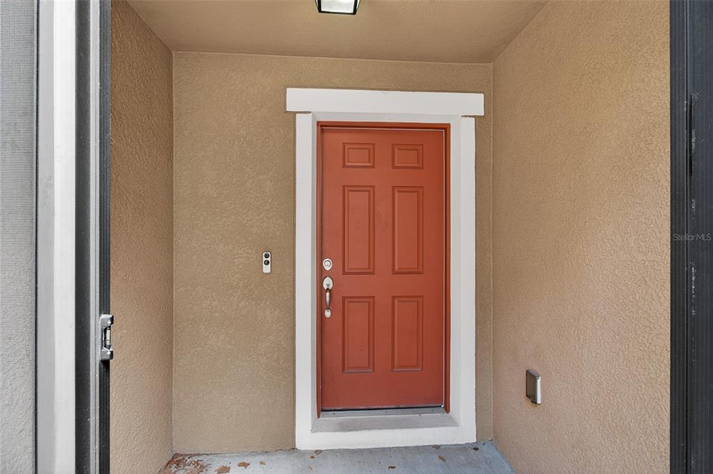 A front entryway features a red six-panel door with white trim and a doorbell — 11154 RUNNING PINE DRIVE DRIVE, RIVERVIEW, FL