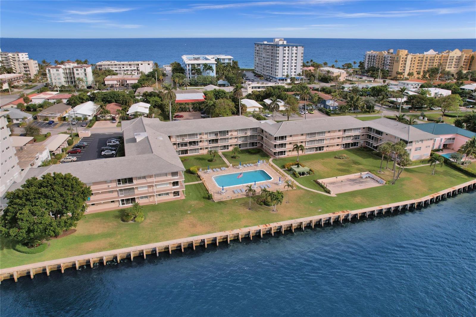 A view of a waterway with houses, docks, and boats under a blue sky — 745 SE 19th Avenue # 134, Deerfield Beach FL 33441, DEERFIELD BEACH, FL