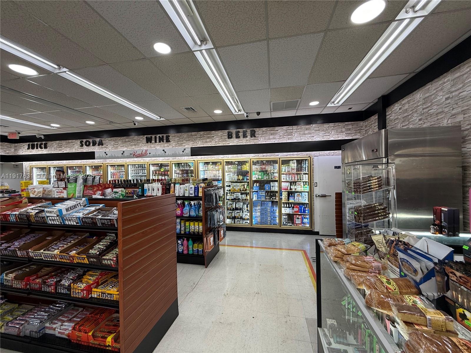 A convenience store interior features refrigerated display cases, snack shelving, and a tiled ceiling — 9510 SW 137TH AVE, Miami FL 33186, MIAMI, FL