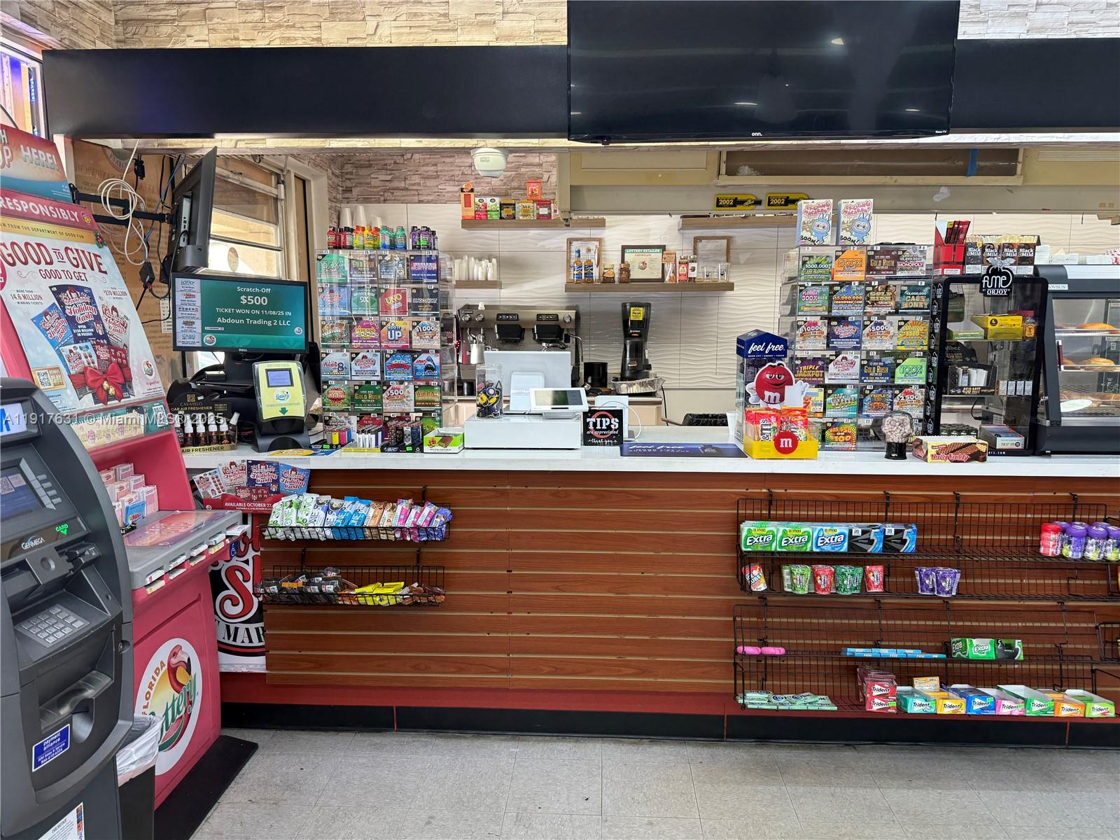 A retail service counter features lottery ticket displays, a point-of-sale system, and snack shelving — 9510 SW 137TH AVE, Miami FL 33186, MIAMI, FL