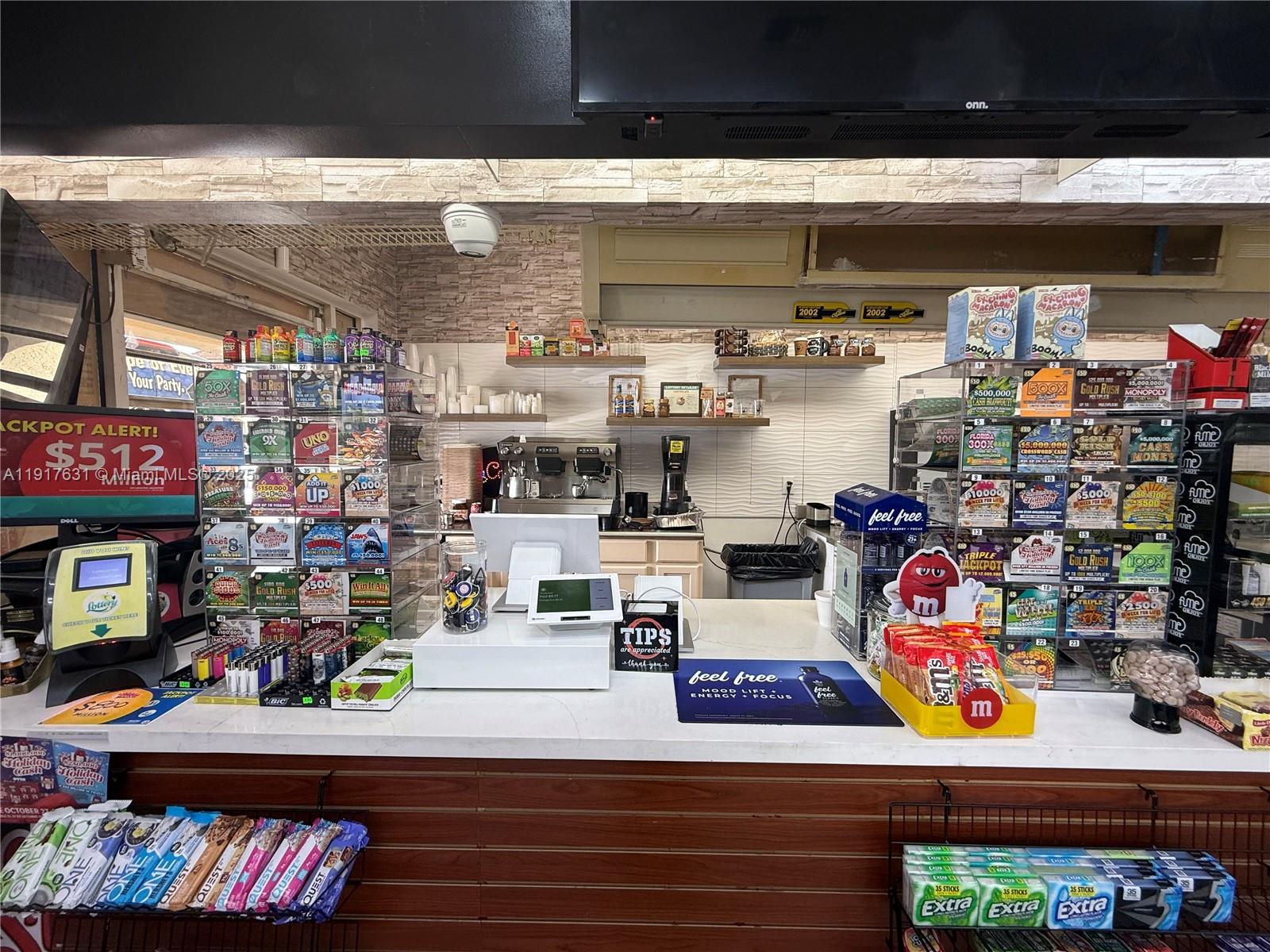 A retail counter features a lottery ticket display, point-of-sale system, and various snack items — 9510 SW 137TH AVE, Miami FL 33186, MIAMI, FL