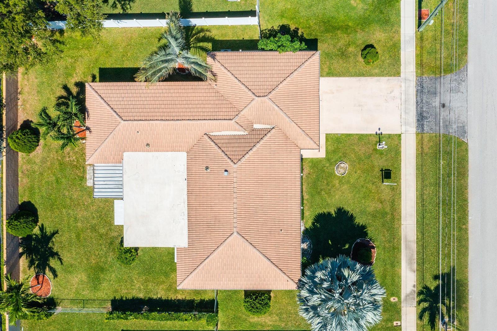 An aerial view shows a single-story house with a tiled roof and a concrete driveway — 3363 NE 6th Drive, Boca Raton FL 33431, BOCA RATON, FL
