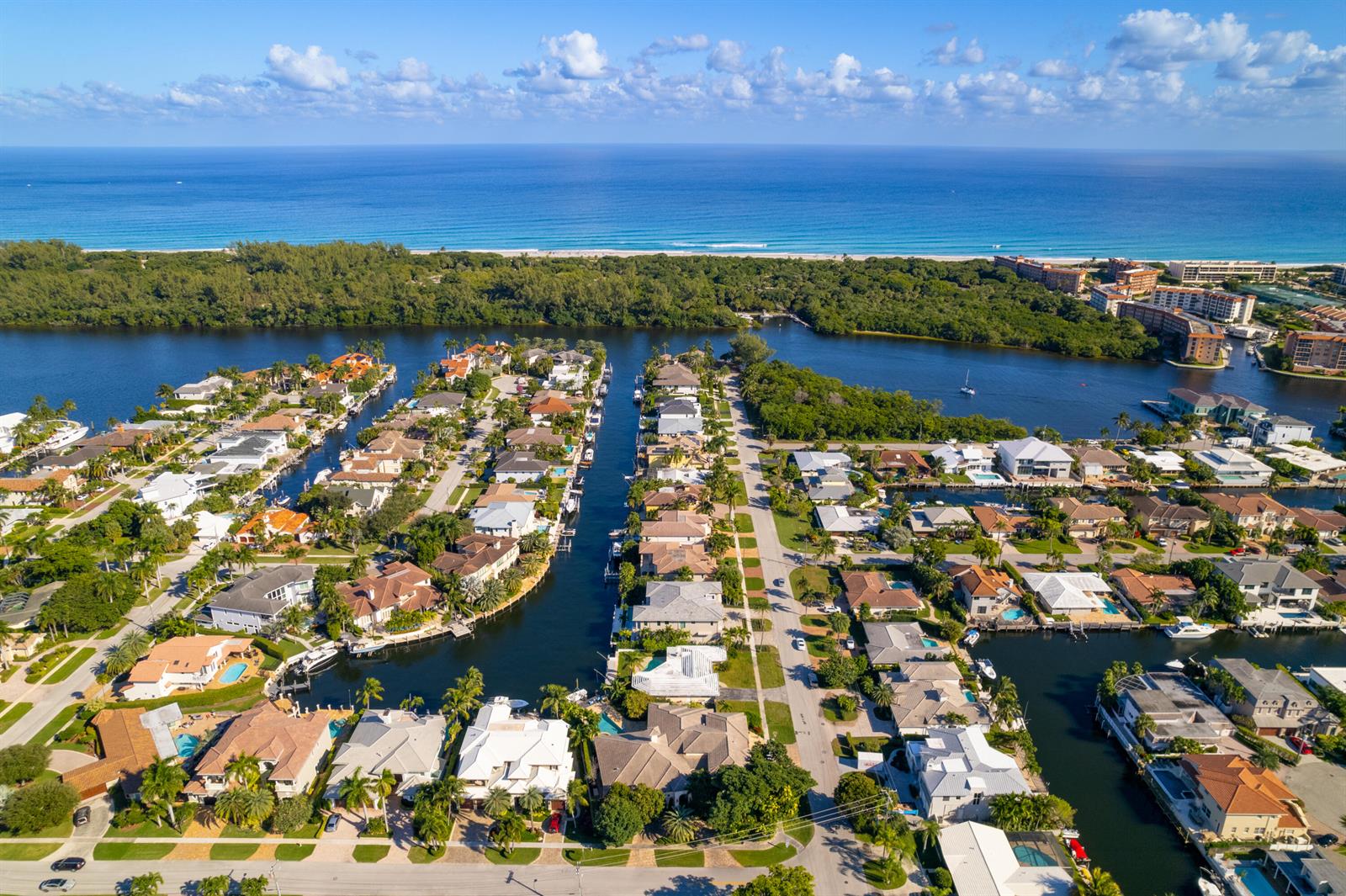 An aerial view shows waterfront homes along a canal leading to the ocean — 3363 NE 6th Drive, Boca Raton FL 33431, BOCA RATON, FL