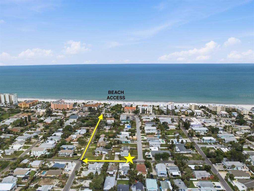 An aerial view shows a coastal neighborhood with a yellow star marking a property location — 1207 1ST STREET, INDIAN ROCKS BEACH, FL