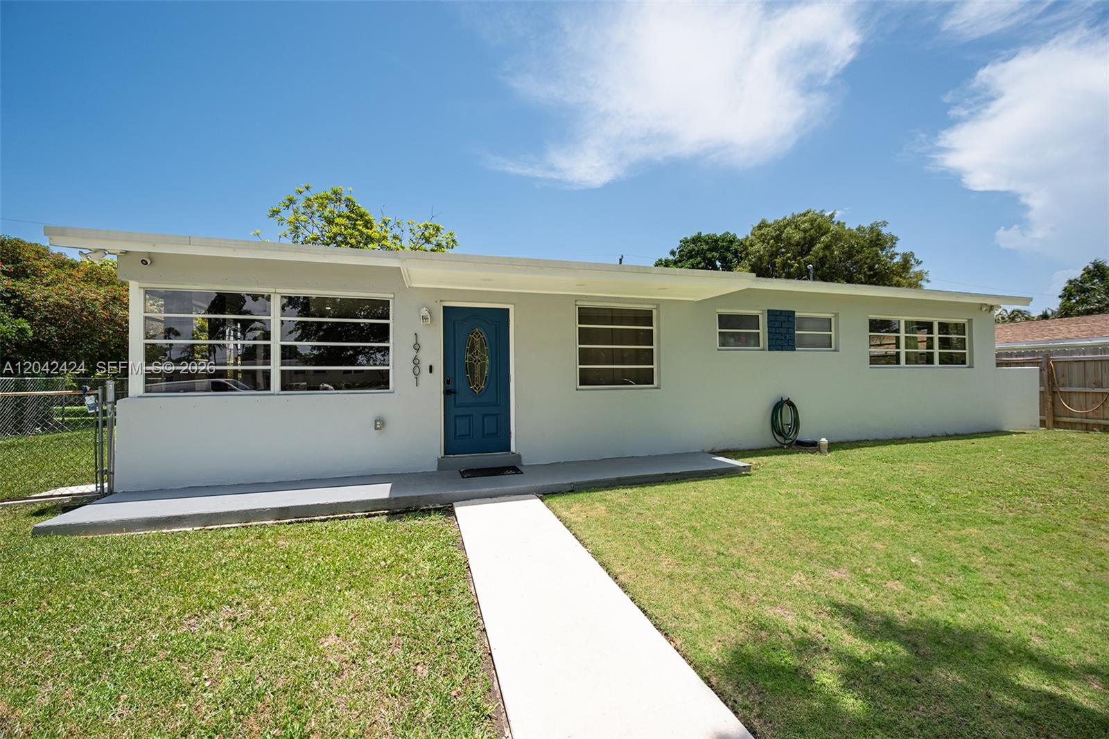 A single-story house with a blue front door, light gray exterior, and a concrete walkway — 19601 Belview Dr, Cutler Bay FL 33157, CUTLER BAY, FL