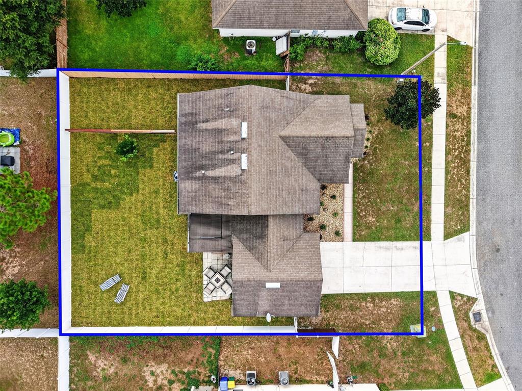 An aerial view shows a single-family home with a fenced backyard and a concrete driveway — 544 TORTOLA AVENUE, TAVARES, FL