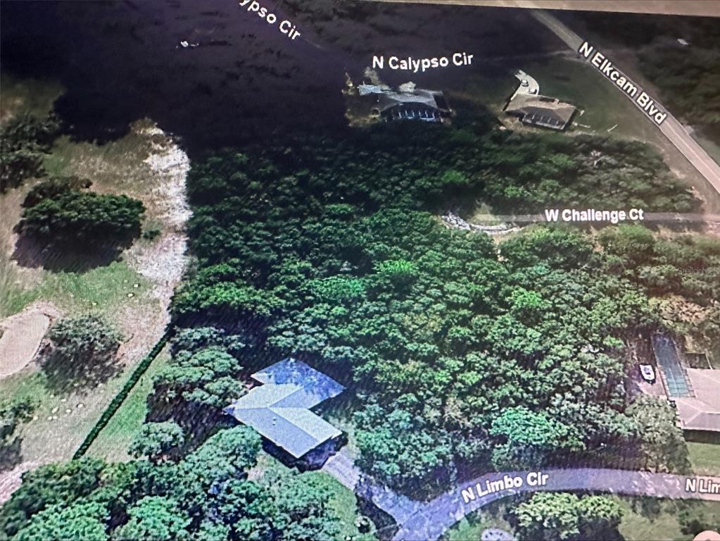 An aerial view shows houses nestled among trees near several residential streets — 2981 W CHALLENGE COURT, CITRUS SPRINGS, FL
