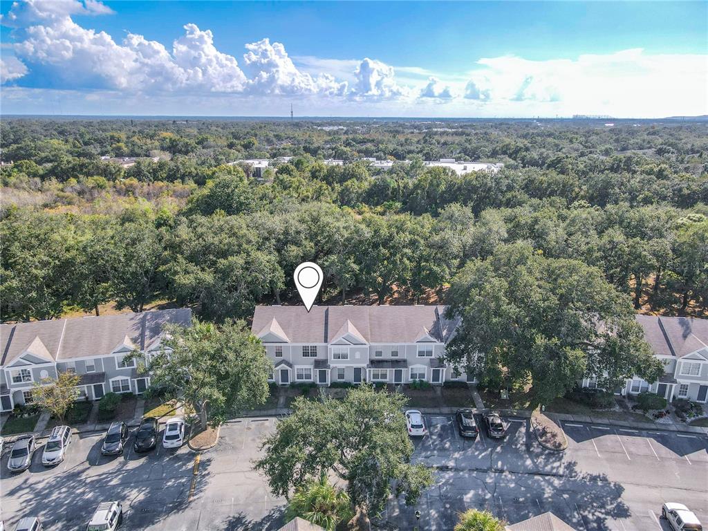 An aerial view shows a row of townhouses with a parking lot in front — 2432 LAKE WOODBERRY CIRCLE, BRANDON, FL