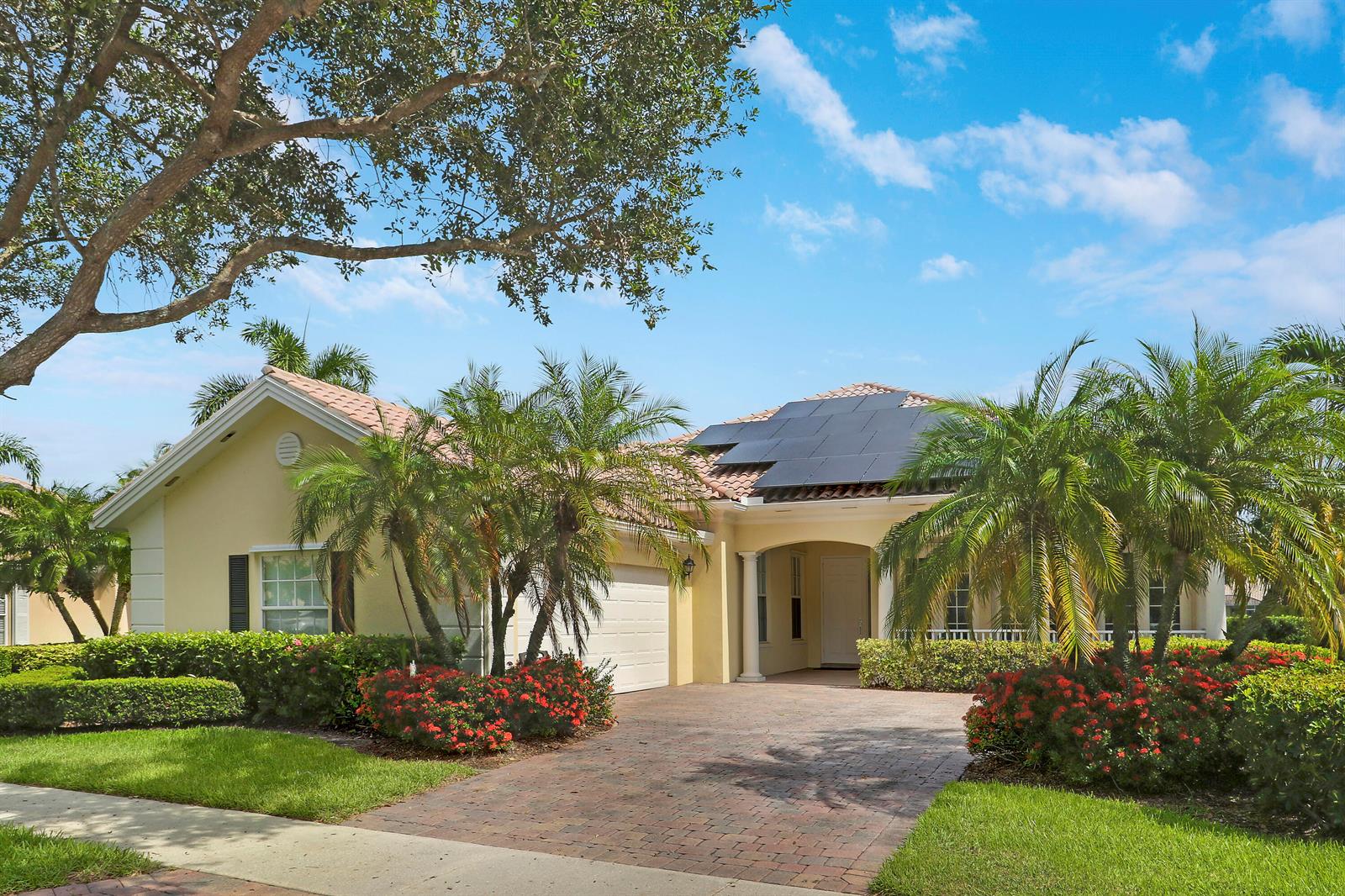 A single-story house with a tiled roof, solar panels, and a paved driveway — 8435 Belize Place, Wellington FL 33414, WELLINGTON, FL