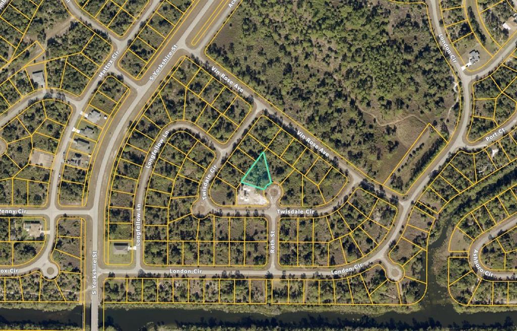 An aerial map view showing a vacant, triangular-shaped residential lot highlighted in light blue — Lot #10 ROTH COURT, NORTH PORT, FL