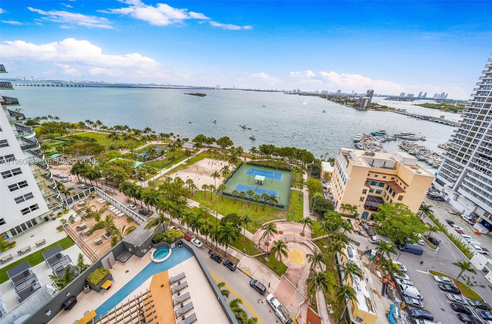 An elevated view shows a waterfront park with tennis courts, a pool, and a marina — 1750 N Bayshore Dr # 2001, Miami FL 33132, MIAMI, FL