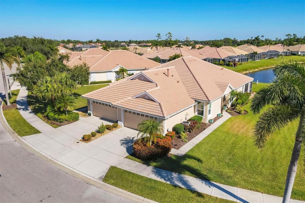 An aerial view of a suburban house with a tile roof and a two-car garage — 4820 WHISPERING OAKS DRIVE, NORTH PORT, FL