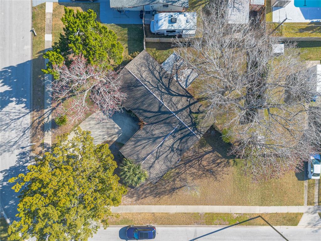 An aerial view shows a house with a dark roof, a driveway, and surrounding trees — 1968 RED CEDAR CIRCLE, SOUTH DAYTONA, FL