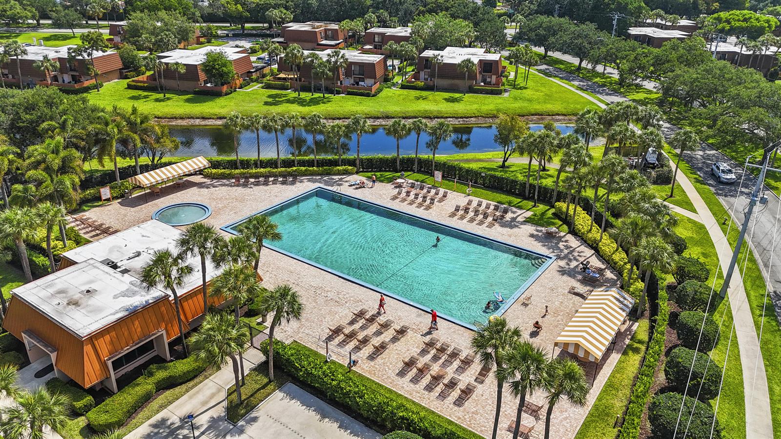 An aerial view shows a rectangular swimming pool, a small circular spa, and lounge chairs — 7813 78th Way, West Palm Beach FL 33407, WEST PALM BEACH, FL