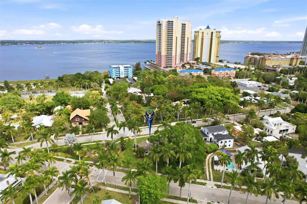An aerial view shows a house marked with a blue pin surrounded by lush tropical trees — 2706 RHODE ISLAND AVENUE, FORT MYERS, FL