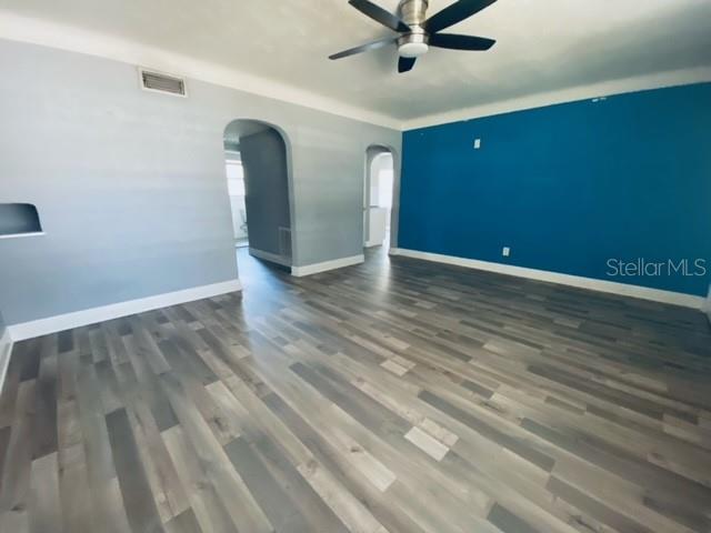 An interior room features light gray walls, a blue accent wall, and wood-look flooring — 2510 14TH STREET S, ST PETERSBURG, FL