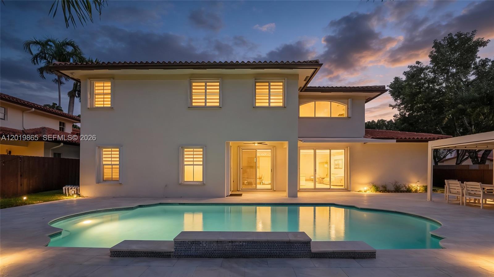 A two-story Mediterranean-style house features a tiled roof, arched entryway, and a paved driveway — 15632 NW 79th Ct, Miami Lakes FL 33016, MIAMI LAKES, FL