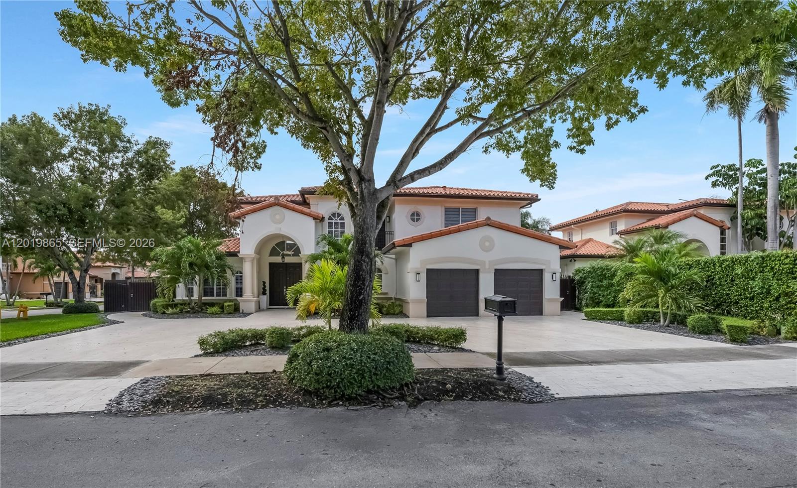A two-story house with a swimming pool and patio at dusk — 15632 NW 79th Ct, Miami Lakes FL 33016, MIAMI LAKES, FL