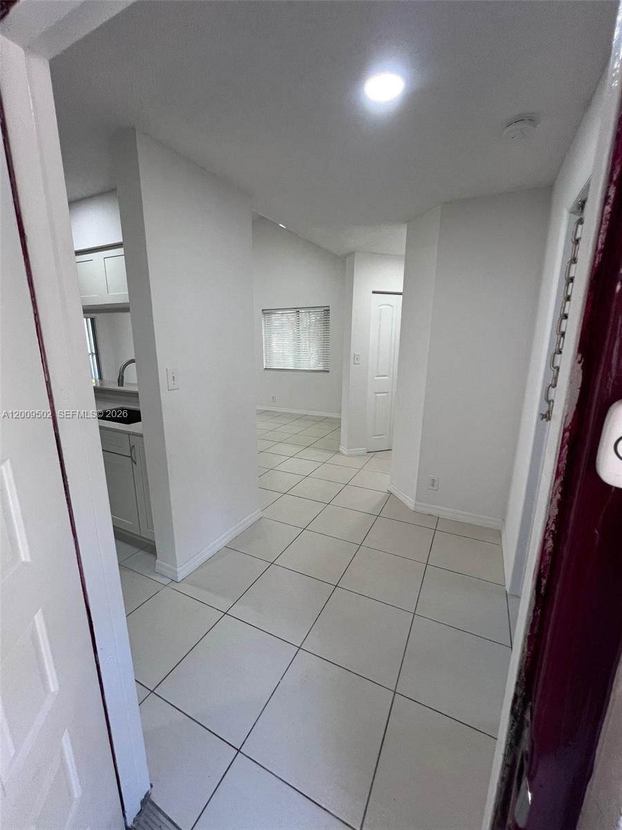 A tiled entryway leads to a hallway with a view into an adjacent room — 9203 SW 138th Pl # 9203, Miami FL 33186, MIAMI, FL