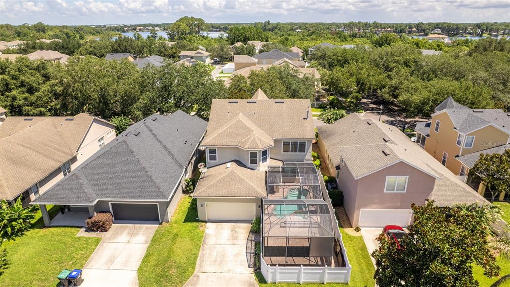An aerial view shows a suburban house with a screened-in pool and a driveway — 12912 DROXFORD ROAD, WINDERMERE, FL