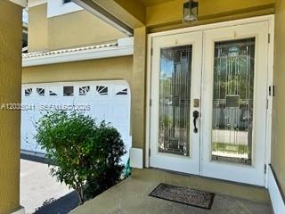 A front entryway features a double glass door with decorative panels and a garage door — 4441 NW 55th Dr, Coconut Creek FL 33073, COCONUT CREEK, FL