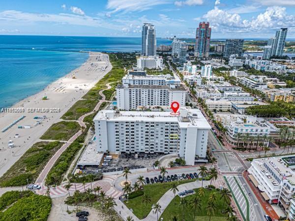 An aerial view shows a multi-story apartment building located next to a sandy beach — 465 Ocean Dr # 524, Miami Beach FL 33139, MIAMI BEACH, FL