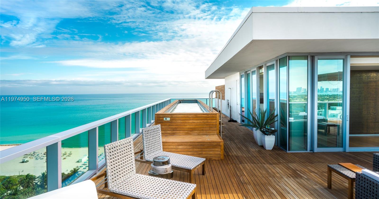 A wooden deck features a rectangular plunge pool, lounge chairs, and glass railings overlooking the ocean — 2901 E Collins Ave # 1602, Miami Beach FL 33140, MIAMI BEACH, FL