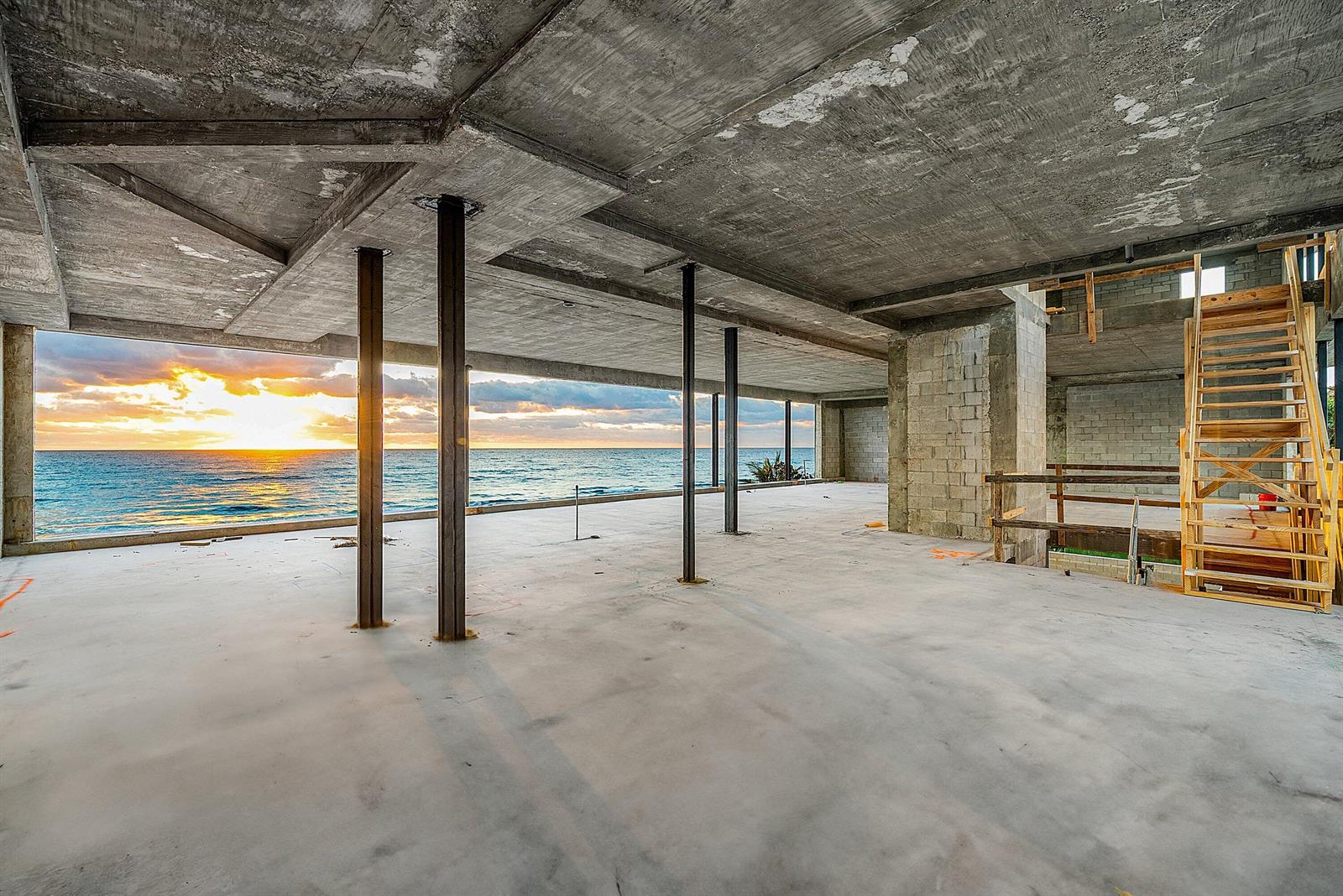 An unfinished concrete room features steel support columns and a wide view of the ocean — 3805 S Ocean Boulevard, Highland Beach FL 33487, HIGHLAND BEACH, FL