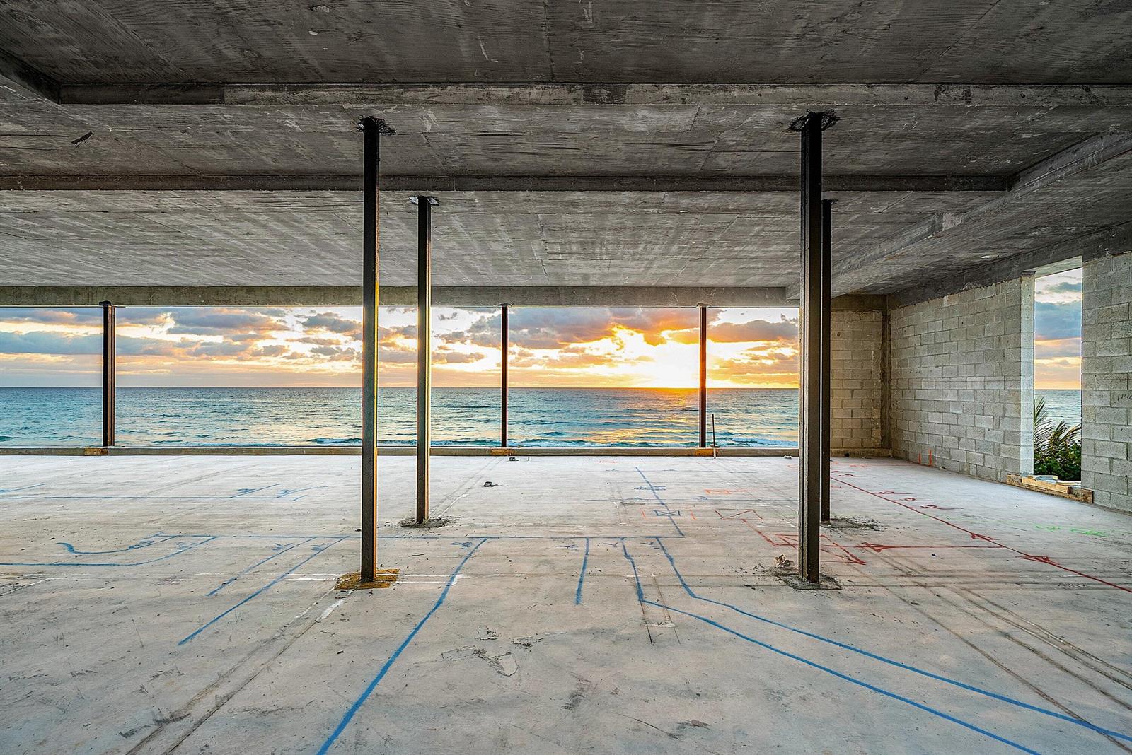 An unfinished concrete room features steel support columns and a wide view of the ocean — 3805 S Ocean Boulevard, Highland Beach FL 33487, HIGHLAND BEACH, FL