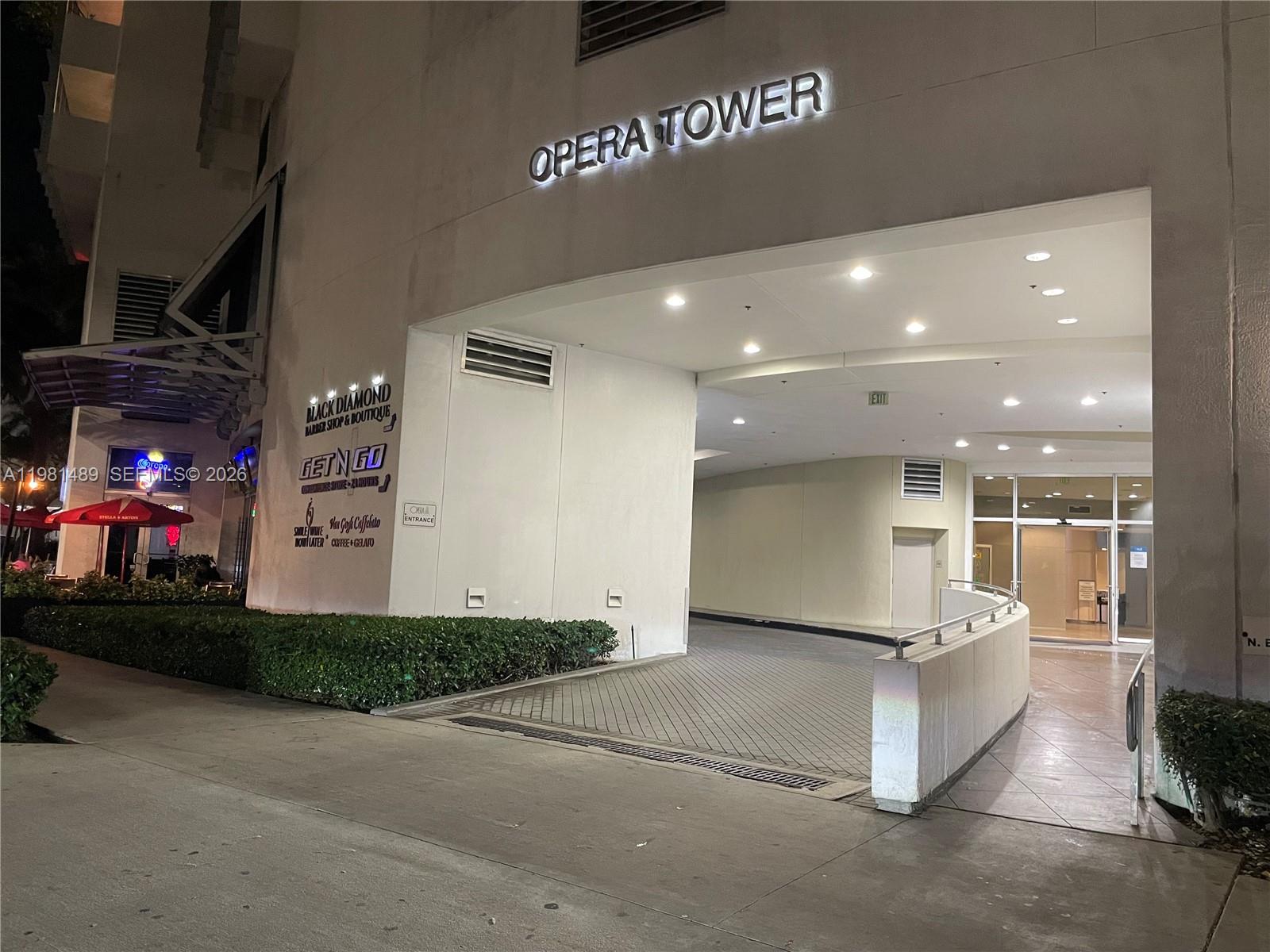 The exterior entrance of the Opera Tower features a driveway ramp and building signage — 1750 N Bayshore Dr # 2814, Miami FL 33132, MIAMI, FL