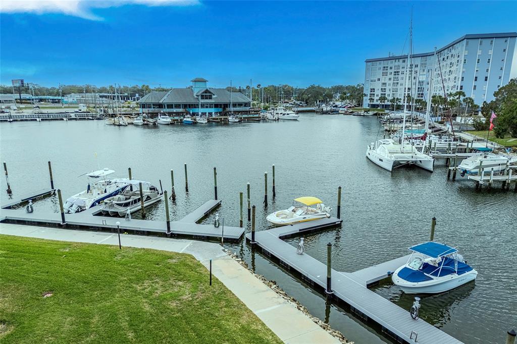 An elevated view of a marina with several boats docked at floating piers — 5197 SILENT LOOP UNIT 224, NEW PORT RICHEY, FL
