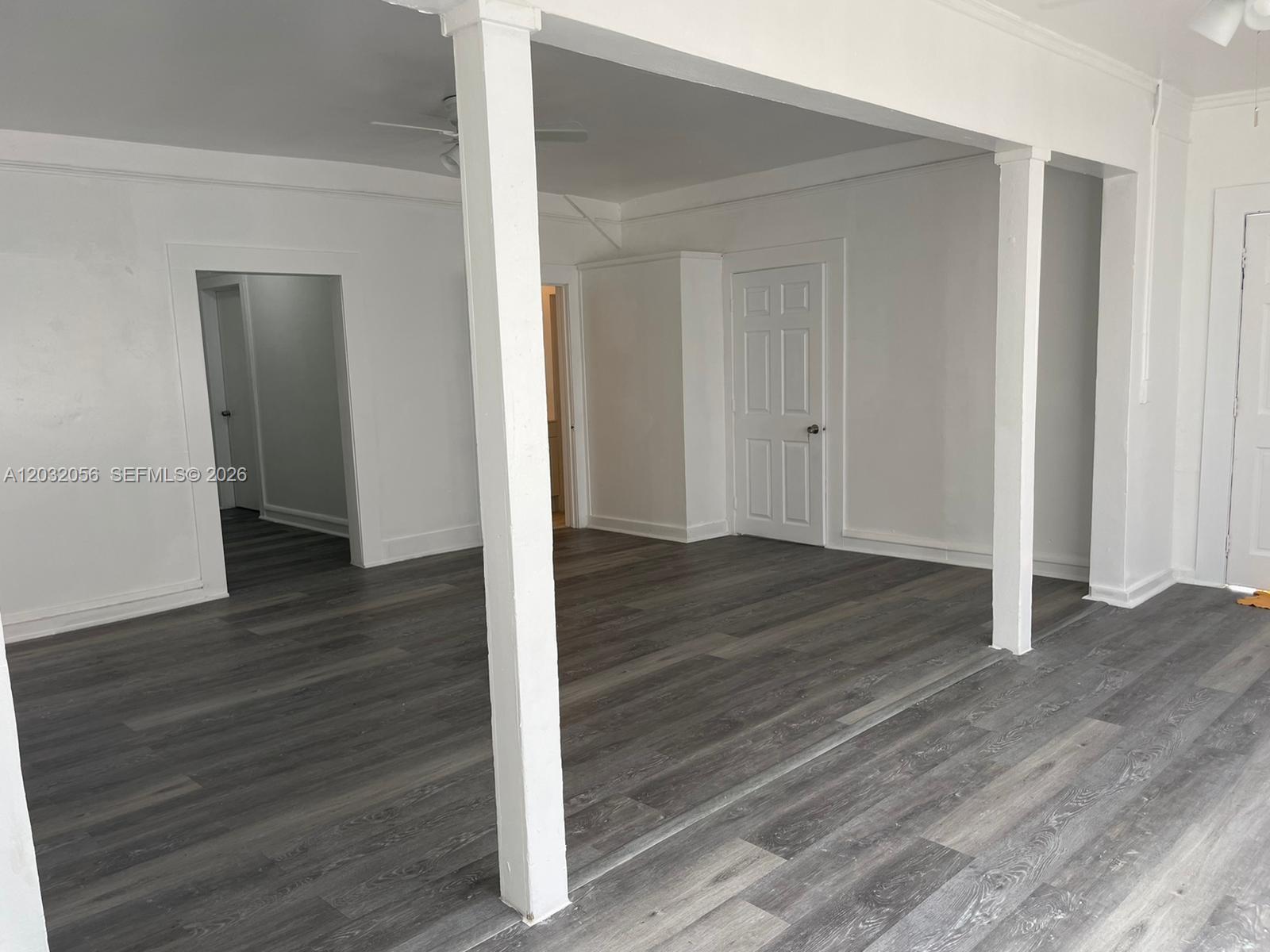 An interior room features white walls, gray wood-look flooring, and two structural support columns — 817 4th St # 817, West Palm Beach FL 33401, WEST PALM BEACH, FL