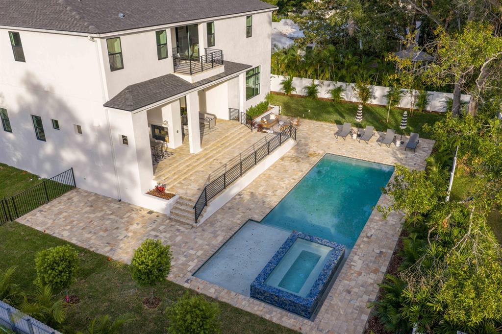 An aerial view of a white house with a tiered patio, pool, and spa — 4624 W SAN JOSE STREET, TAMPA, FL