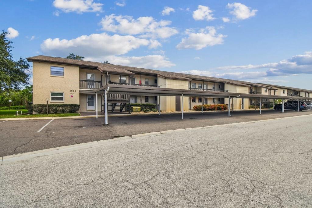 A two-story apartment building with a covered parking area in front — 4829 ONYX LANE UNIT 101, NEW PORT RICHEY, FL