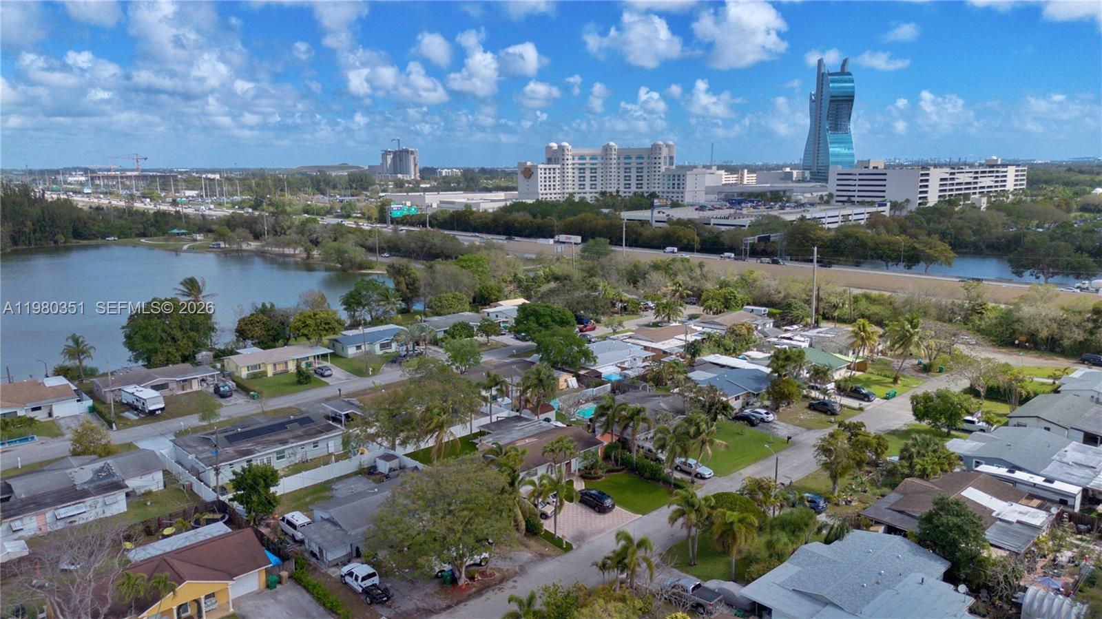 An aerial view shows a residential neighborhood near a lake and a large hotel complex — 5220 SW 57th St, Davie FL 33314, DAVIE, FL